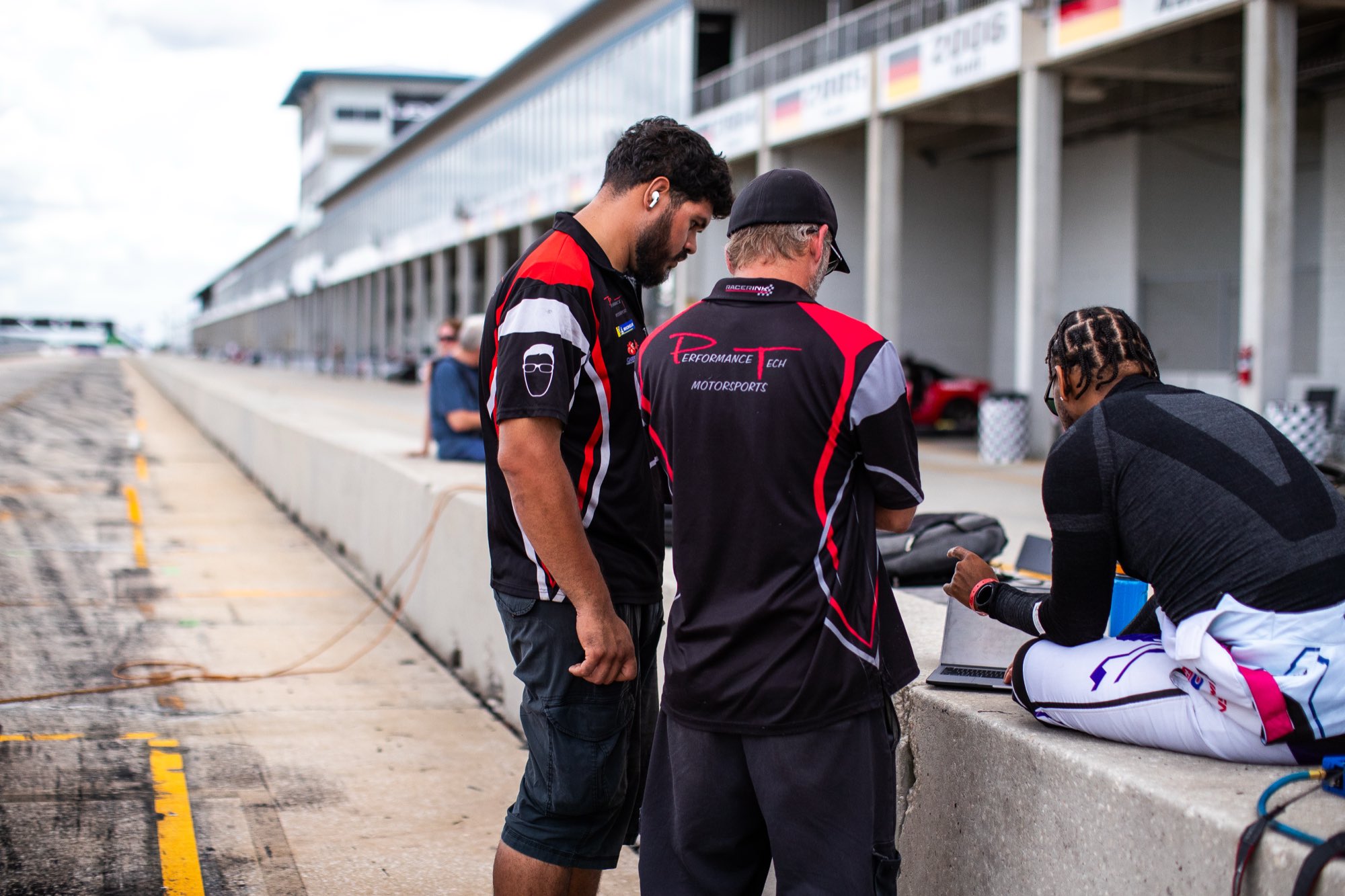 Daniel and the crew reviewing live telemetry on the pit wall at the track